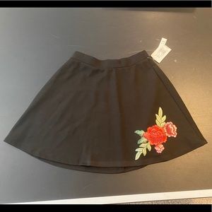 Joe B black short skirt with imprinted rose S